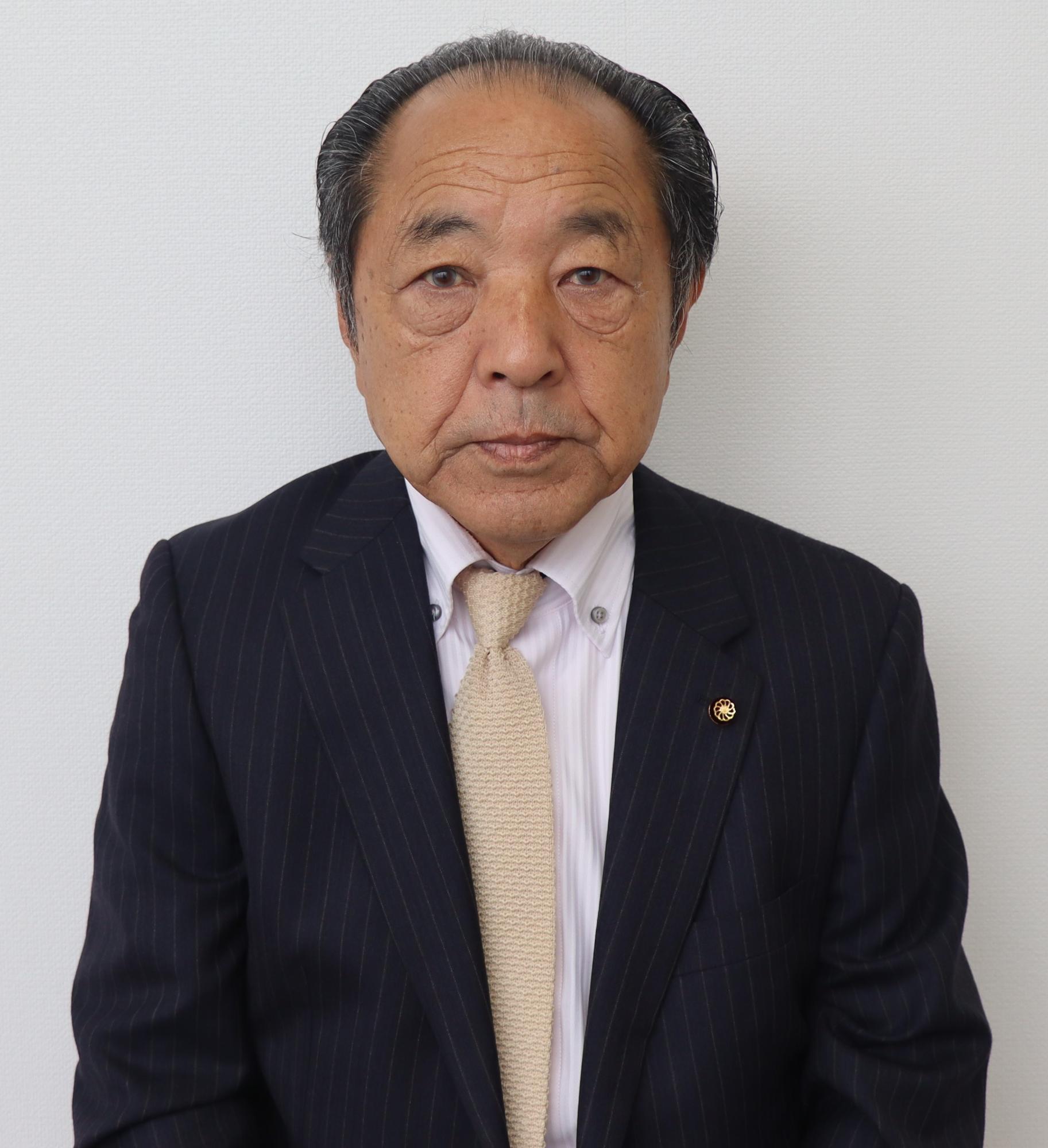 黒いスーツ姿の男性、工藤 義明（くどう よしあき）の写真